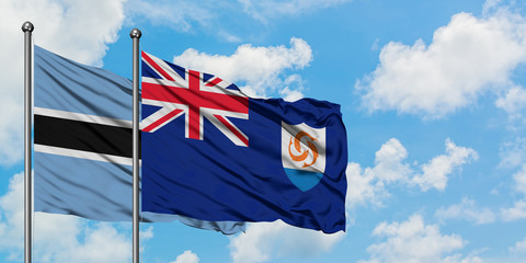 Botswana and Anguilla flag waving in the wind against white cloudy blue sky together. Diplomacy concept, international relations.