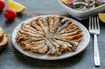 Fried anchovies fish and salad