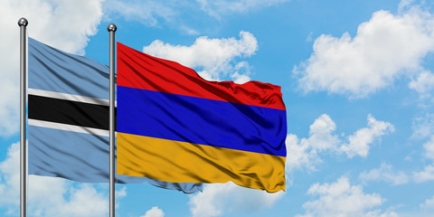 Botswana and Armenia flag waving in the wind against white cloudy blue sky together. Diplomacy concept, international relations.