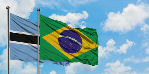 Botswana and Brazil flag waving in the wind against white cloudy blue sky together. Diplomacy concept, international relations.