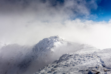 Maliovica peak in the mists of the clouds at the Rila mountain in Bulgaria.
