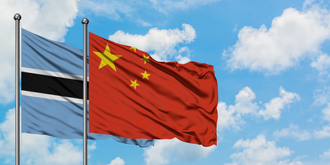 Botswana and China flag waving in the wind against white cloudy blue sky together. Diplomacy concept, international relations.