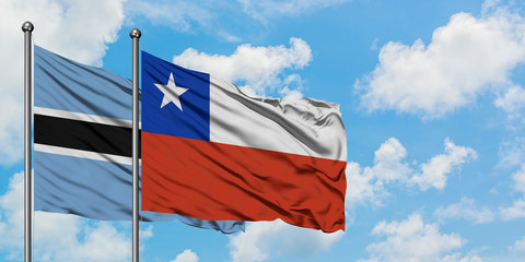Botswana and Chile flag waving in the wind against white cloudy blue sky together. Diplomacy concept, international relations.