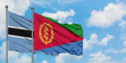Botswana and Eritrea flag waving in the wind against white cloudy blue sky together. Diplomacy concept, international relations.