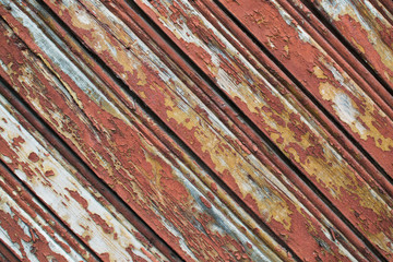 Vintage painted wood background with peeling paint. Wooden texture planks placed obliquely. Layout for design, copy space.