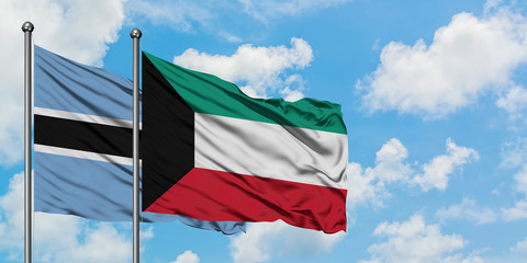 Botswana and Kuwait flag waving in the wind against white cloudy blue sky together. Diplomacy concept, international relations.