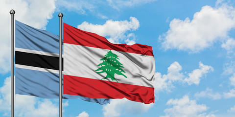 Botswana and Lebanon flag waving in the wind against white cloudy blue sky together. Diplomacy concept, international relations.