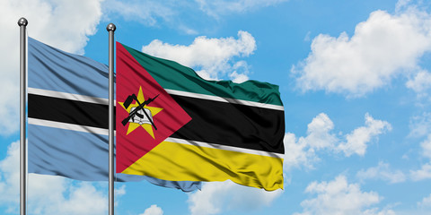 Botswana and Mozambique flag waving in the wind against white cloudy blue sky together. Diplomacy concept, international relations.