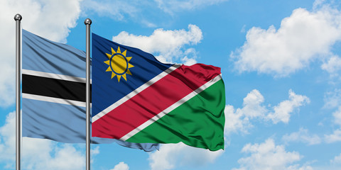 Botswana and Namibia flag waving in the wind against white cloudy blue sky together. Diplomacy concept, international relations.