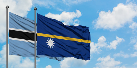 Botswana and Nauru flag waving in the wind against white cloudy blue sky together. Diplomacy concept, international relations.