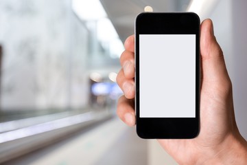 Hand holding black smartphone on mall background