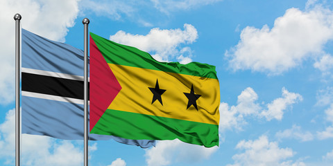 Botswana and Sao Tome And Principe flag waving in the wind against white cloudy blue sky together. Diplomacy concept, international relations.
