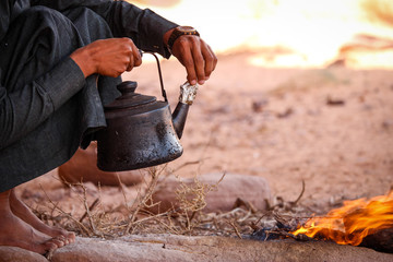 Bedouin tea preparation in the desert of Wadi Rum Jordan - obrazy, fototapety, plakaty