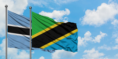 Botswana and Tanzania flag waving in the wind against white cloudy blue sky together. Diplomacy concept, international relations.