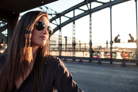 Young woman on a bridge in the evening light