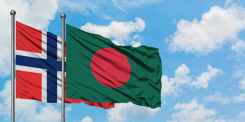 Bouvet Islands and Bangladesh flag waving in the wind against white cloudy blue sky together. Diplomacy concept, international relations.
