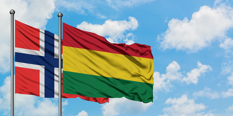 Bouvet Islands and Bolivia flag waving in the wind against white cloudy blue sky together. Diplomacy concept, international relations.