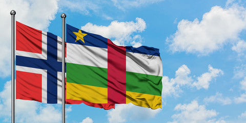 Bouvet Islands and Central African Republic flag waving in the wind against white cloudy blue sky together. Diplomacy concept, international relations.