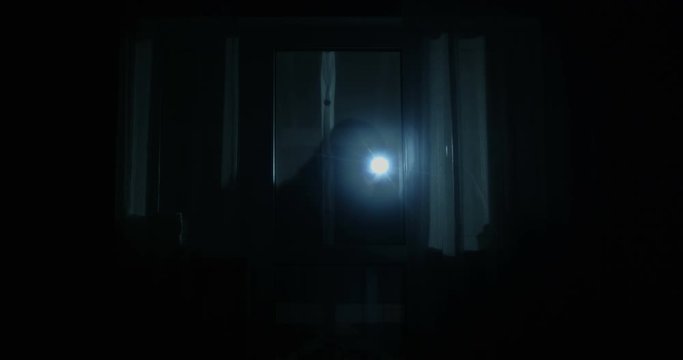 Thief is Looking inside the House Through the Windows with Flashlight Opening the Back Door and Entering the Property at Night Shot on Red Epic