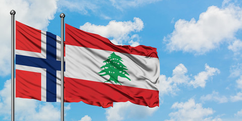 Bouvet Islands and Lebanon flag waving in the wind against white cloudy blue sky together. Diplomacy concept, international relations.
