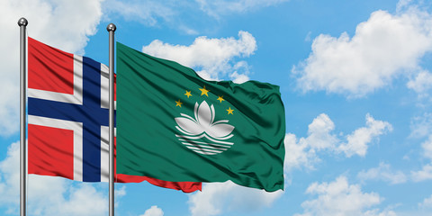 Bouvet Islands and Macao flag waving in the wind against white cloudy blue sky together. Diplomacy concept, international relations.