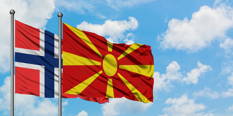 Bouvet Islands and Macedonia flag waving in the wind against white cloudy blue sky together. Diplomacy concept, international relations.
