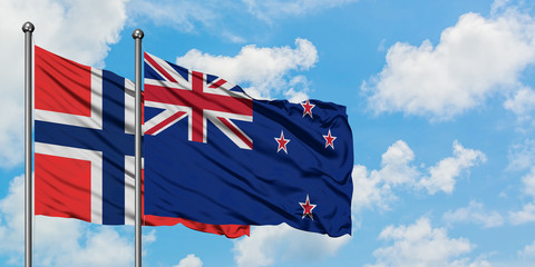 Bouvet Islands and New Zealand flag waving in the wind against white cloudy blue sky together. Diplomacy concept, international relations.