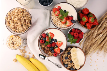 Tasty homemade granola served on table. Healthy breakfast with a bowl of oatmeal with banana, blueberries, strawberries and healthy food for Breakfast