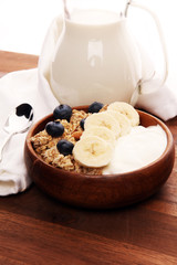 Tasty homemade granola served on table. Healthy breakfast with a bowl of oatmeal with banana, blueberries, strawberries and healthy food for Breakfast