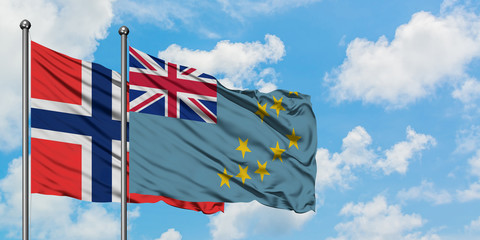 Bouvet Islands and Tuvalu flag waving in the wind against white cloudy blue sky together. Diplomacy concept, international relations.