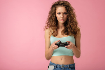 Fototapeta na wymiar Pretty gamer girl isolated on pink background
