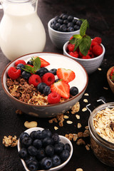 Tasty homemade granola served on table. Healthy breakfast with a bowl of oatmeal with banana, blueberries, strawberries and healthy food for Breakfast