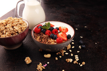 Tasty homemade granola served on table. Healthy breakfast with a bowl of oatmeal with banana, blueberries, strawberries and healthy food for Breakfast