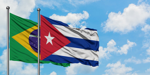 Brazil and Cuba flag waving in the wind against white cloudy blue sky together. Diplomacy concept, international relations.