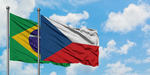 Brazil and Czech Republic flag waving in the wind against white cloudy blue sky together. Diplomacy concept, international relations.