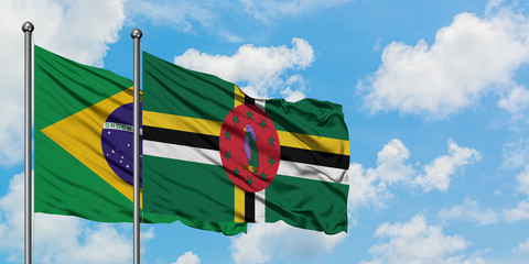 Brazil and Dominica flag waving in the wind against white cloudy blue sky together. Diplomacy concept, international relations.