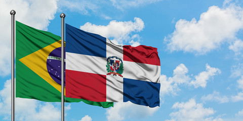 Brazil and Dominican Republic flag waving in the wind against white cloudy blue sky together. Diplomacy concept, international relations.