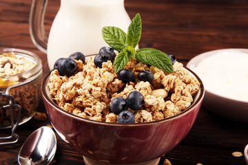 Tasty homemade granola served on table. Healthy breakfast with a bowl of oatmeal with banana, blueberries, strawberries and healthy food for Breakfast