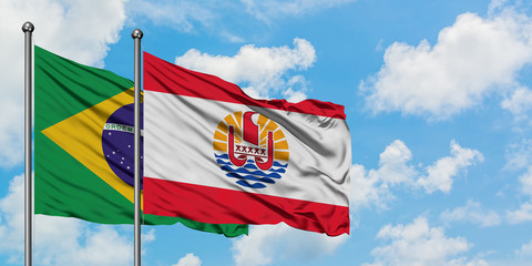 Brazil and French Polynesia flag waving in the wind against white cloudy blue sky together. Diplomacy concept, international relations.