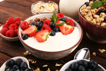 Tasty homemade granola served on table. Healthy breakfast with a bowl of oatmeal with banana, blueberries, strawberries and healthy food for Breakfast