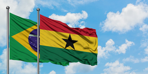 Brazil and Ghana flag waving in the wind against white cloudy blue sky together. Diplomacy concept, international relations.