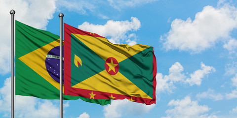 Brazil and Grenada flag waving in the wind against white cloudy blue sky together. Diplomacy concept, international relations.