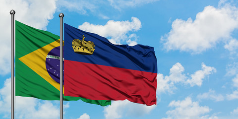 Brazil and Liechtenstein flag waving in the wind against white cloudy blue sky together. Diplomacy concept, international relations.