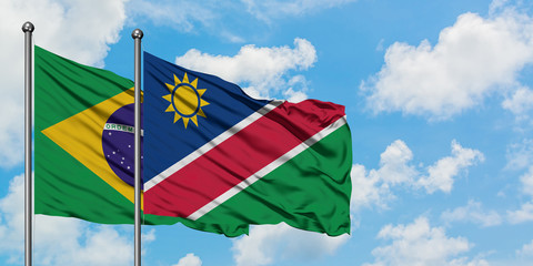 Brazil and Namibia flag waving in the wind against white cloudy blue sky together. Diplomacy concept, international relations.