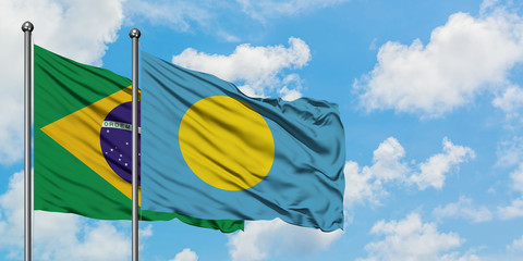 Brazil and Palau flag waving in the wind against white cloudy blue sky together. Diplomacy concept, international relations.