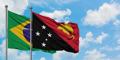 Brazil and Papua New Guinea flag waving in the wind against white cloudy blue sky together. Diplomacy concept, international relations.