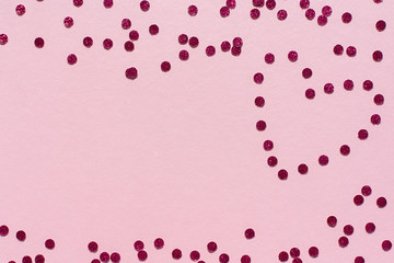 Holiday background, Valentine's Day, the heart of the bright confetti on a pink background
