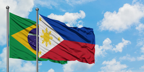Brazil and Philippines flag waving in the wind against white cloudy blue sky together. Diplomacy concept, international relations.