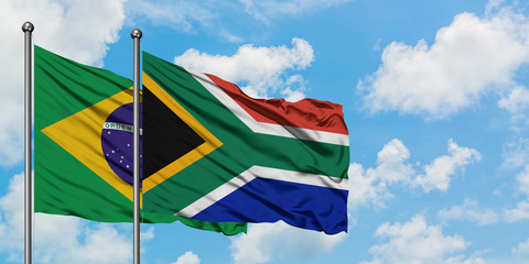 Brazil and South Africa flag waving in the wind against white cloudy blue sky together. Diplomacy concept, international relations.