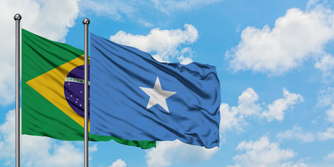 Brazil and Somalia flag waving in the wind against white cloudy blue sky together. Diplomacy concept, international relations.